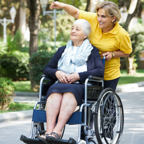 Careful caregiver taking care of the patient, outdoors.