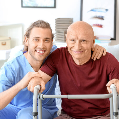 Elderly man with caregiver in nursing home